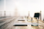 Board room table with pen and water glass