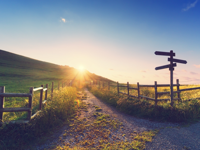 Sign and path at sunrise